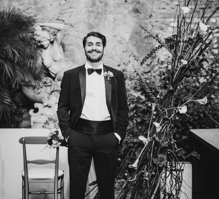 Groom smiling wearing a classic black tuxedo