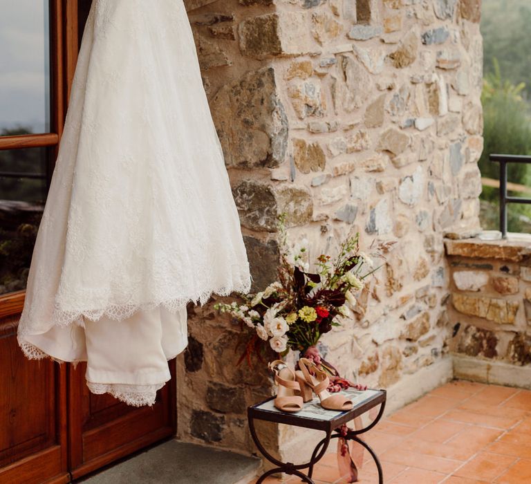 Strapless lace white wedding dress hanging up for an elopement in Italy