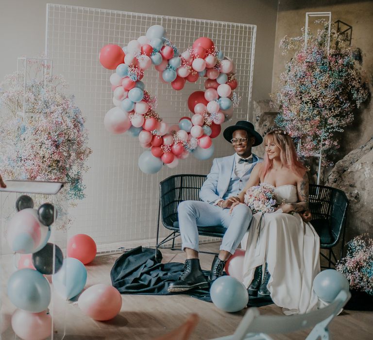 Celebrant at intimate candy inspired wedding with pastel flowers and balloons and black accents 