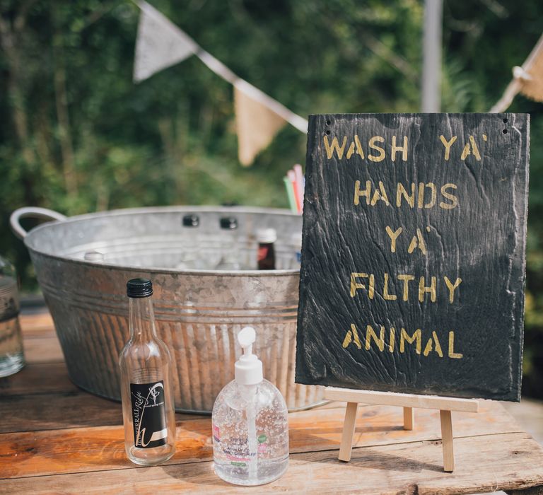 Chalkboard wedding sign with 'wash your hands you filthy animal' 