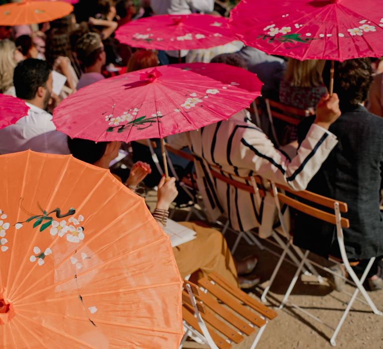 Orange and pink parasols for guests