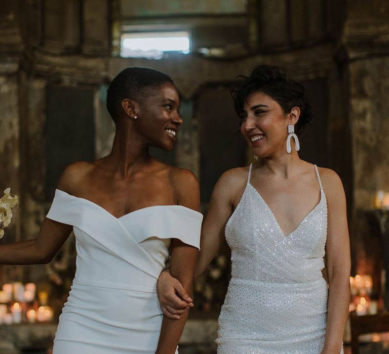 Two brides in off the shoulder and sparkly fitted wedding dresses 