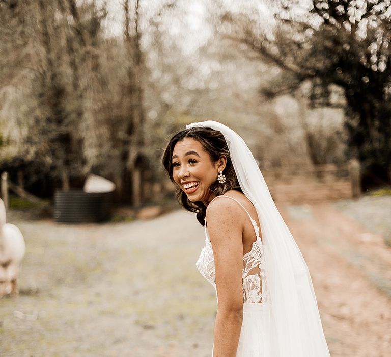 Beautiful bride in a tulle skirt wedding dress with long veil 