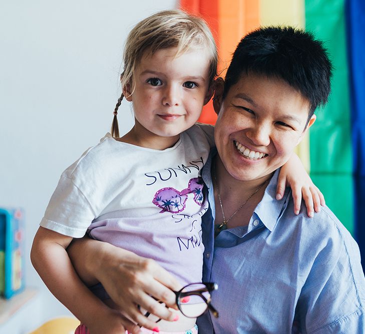 Bride poses for photo with little boy on her wedding day