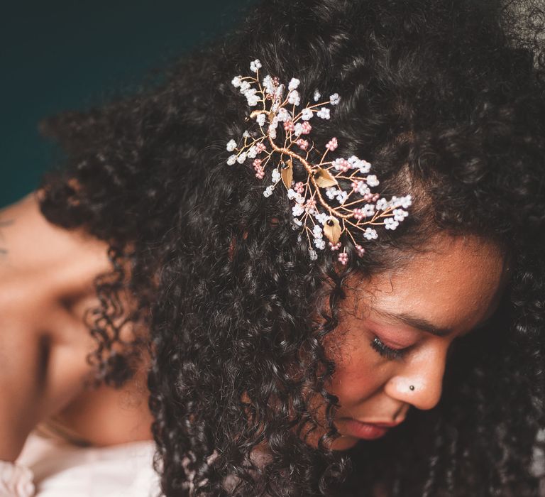 black bride with naturally curly hair wearing a wire hair accessory 