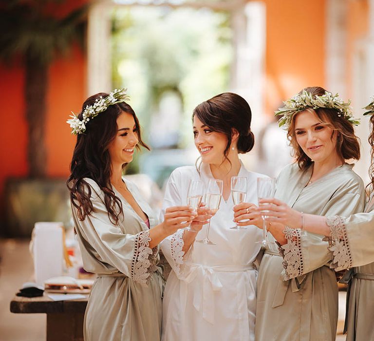 Bride & her bridesmaids cheers with champagne on the morning of wedding 