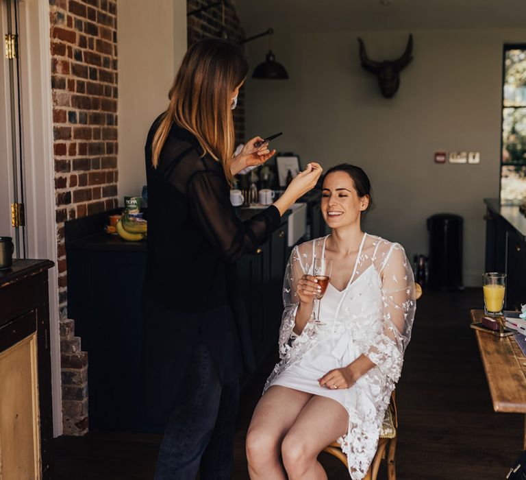 Bride having hair up do & make up in bridal sequin unique bridal dressing gown  