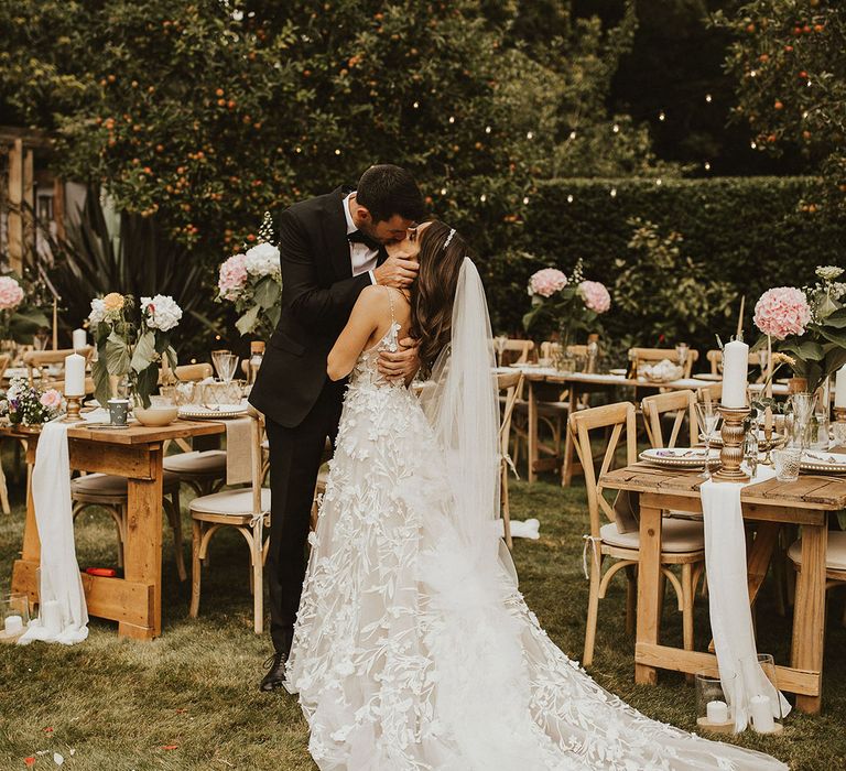 Bride & groom kiss outdoors on their wedding day