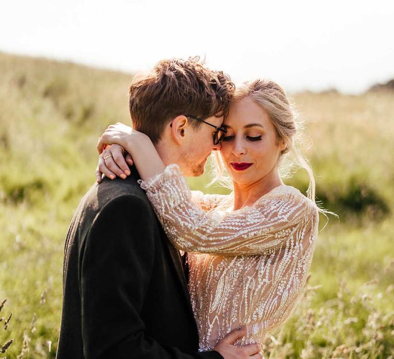 Bride & groom hug on their wedding day whilst outdoors in Scotland