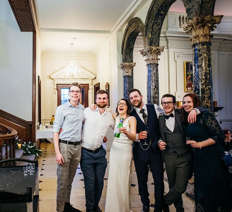 Wedding guests celebrate with bride & groom