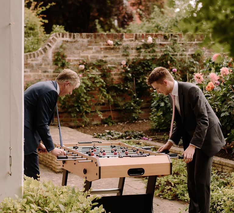 Wedding guests play table football