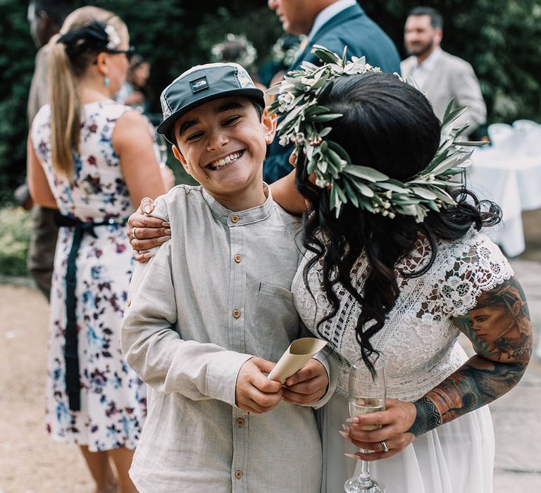 Bride leans in to child on her wedding day