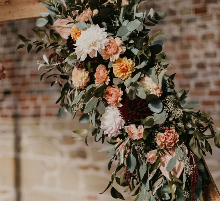 Wooden hexagon altar with peach, white a green foliage floral decoration 