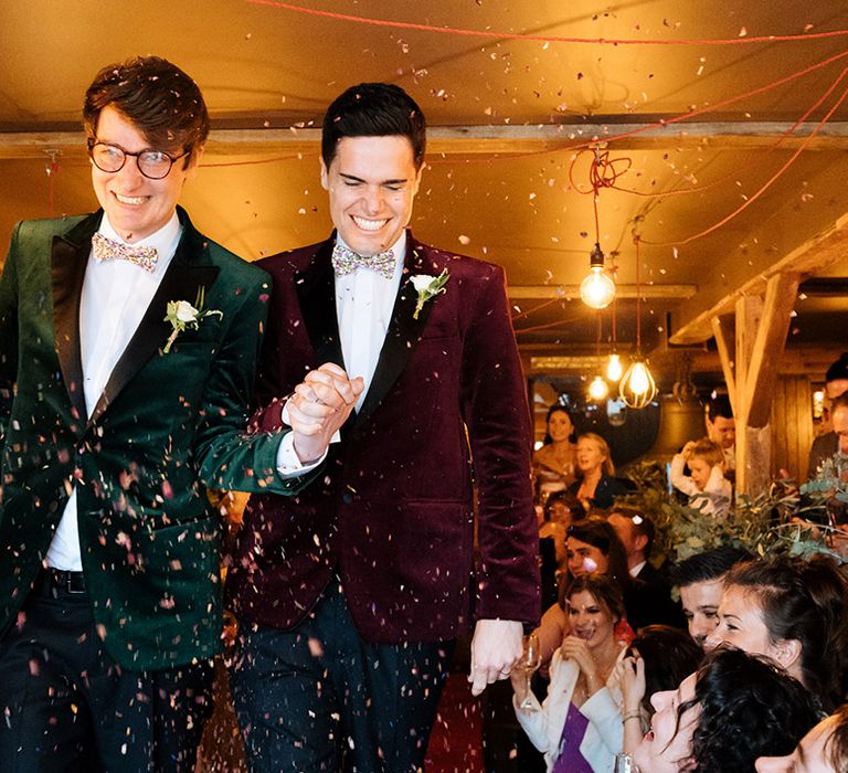 Grooms in velvet tuxedo jackets have their confetti exit at wedding 