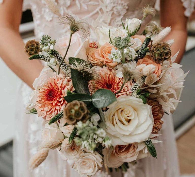 Sweetheart off the shoulder flower lace wedding dress with orange flowers, white roses and other greenery wedding bouquet 