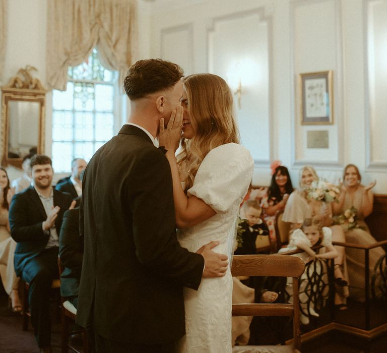 Happy bride and groom share their first kiss as husband and wife