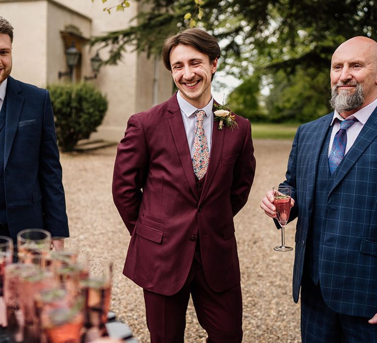 Groom with groomsmen and wedding guests getting some drinks before the ceremony 