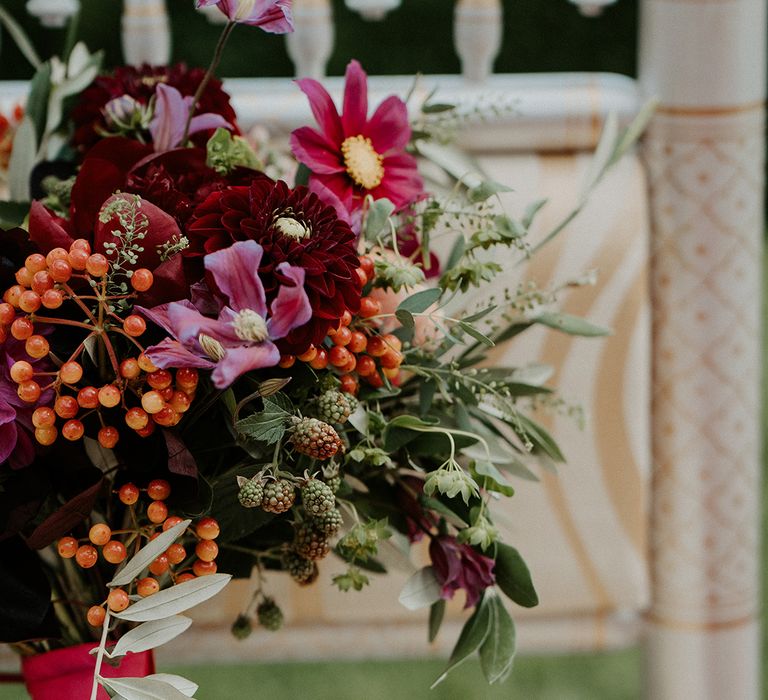 Brightly coloured floral bouquet featuring summer blooms tied with pink ribbon 