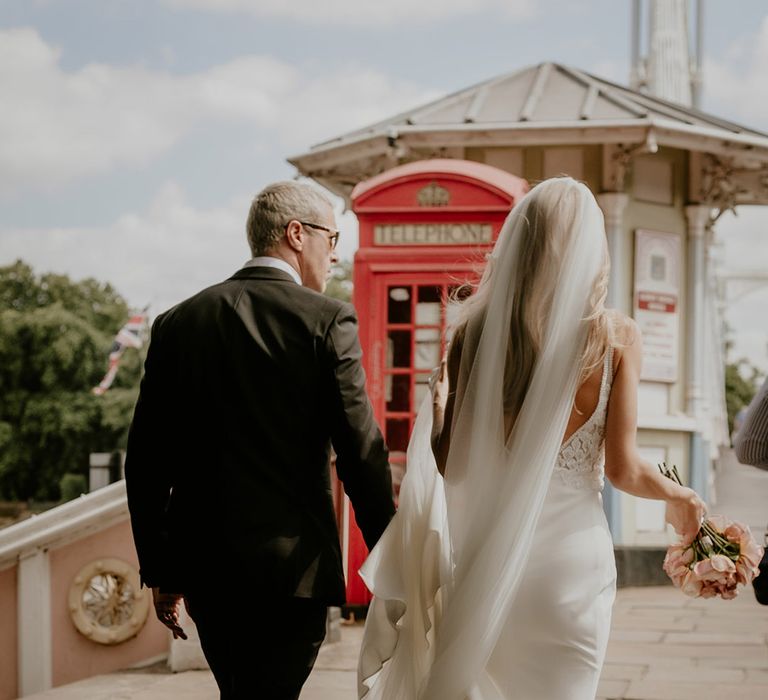 Bride and groom walk around London on their wedding day 