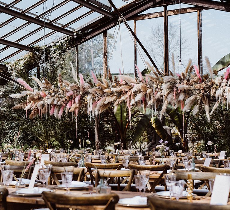 Large neutral and pink pampas grass flower cloud decoration in the Anran glass house wedding venue 