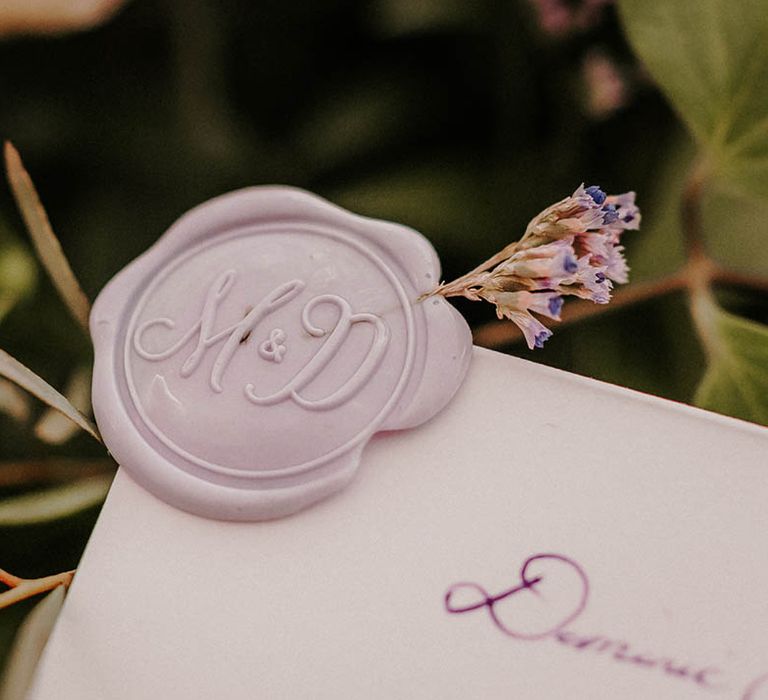 Purple wax seal with sprig of lavender on the wedding invite 