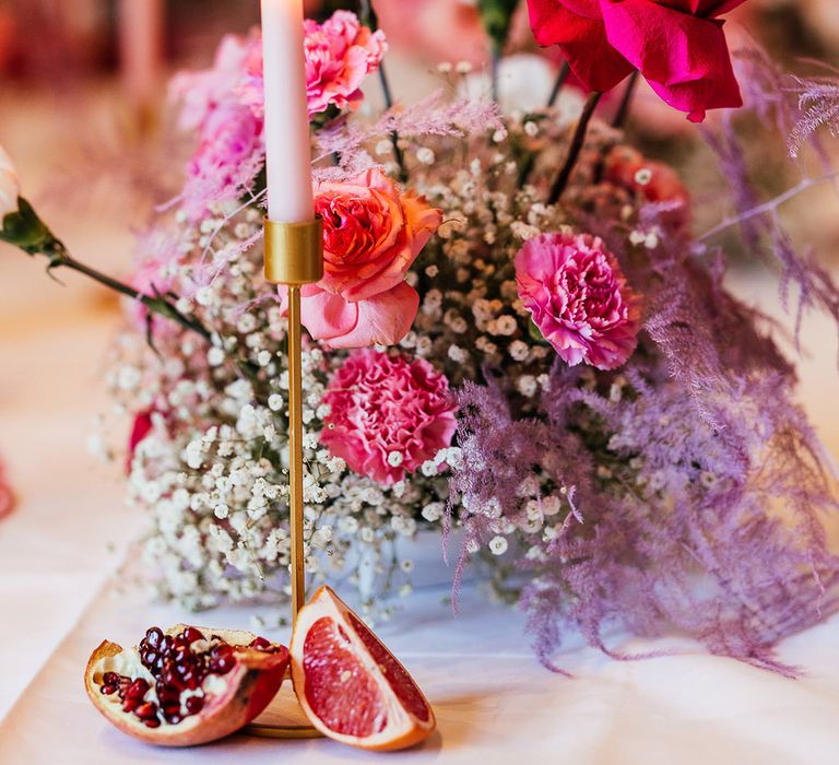 Bright and colourful magenta wedding flowers for the table centrepiece 