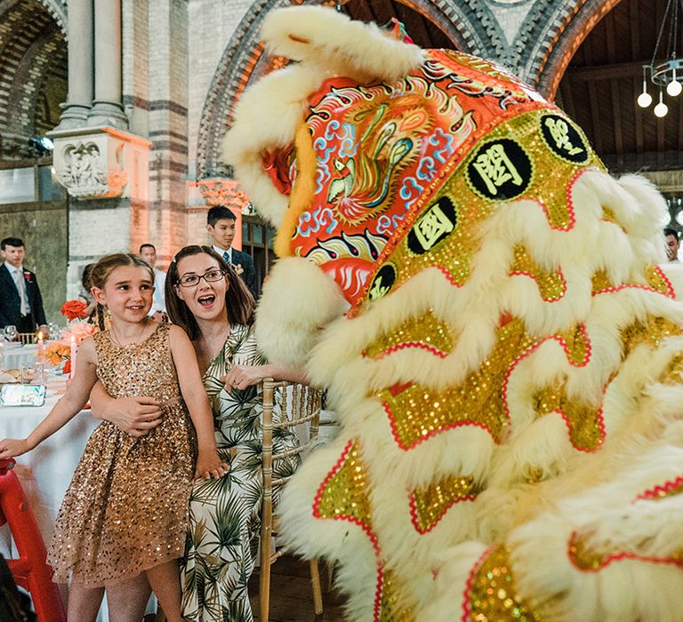 Colourful Lion Troupe dance during wedding reception at St Stephen's Hampstead church