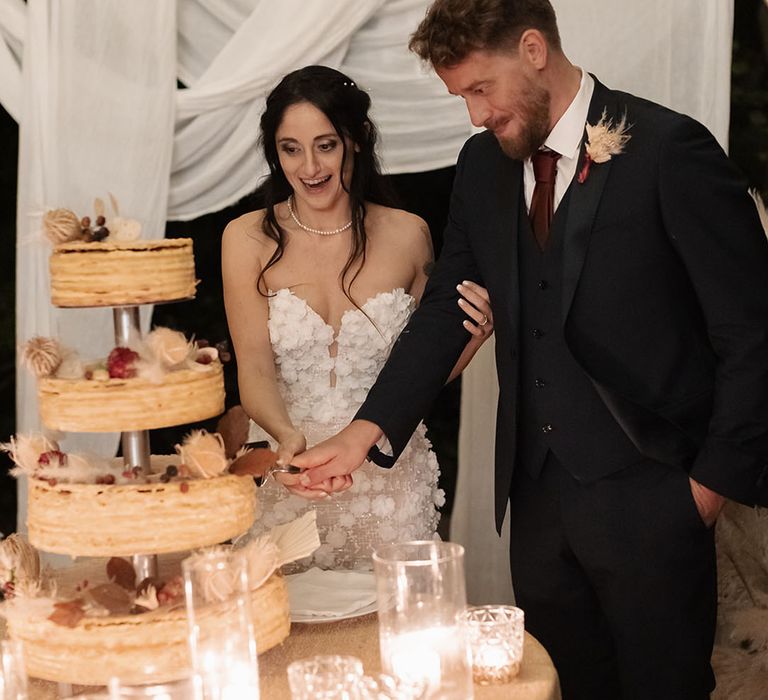 Bride & groom cut four tier Opera wedding cake 