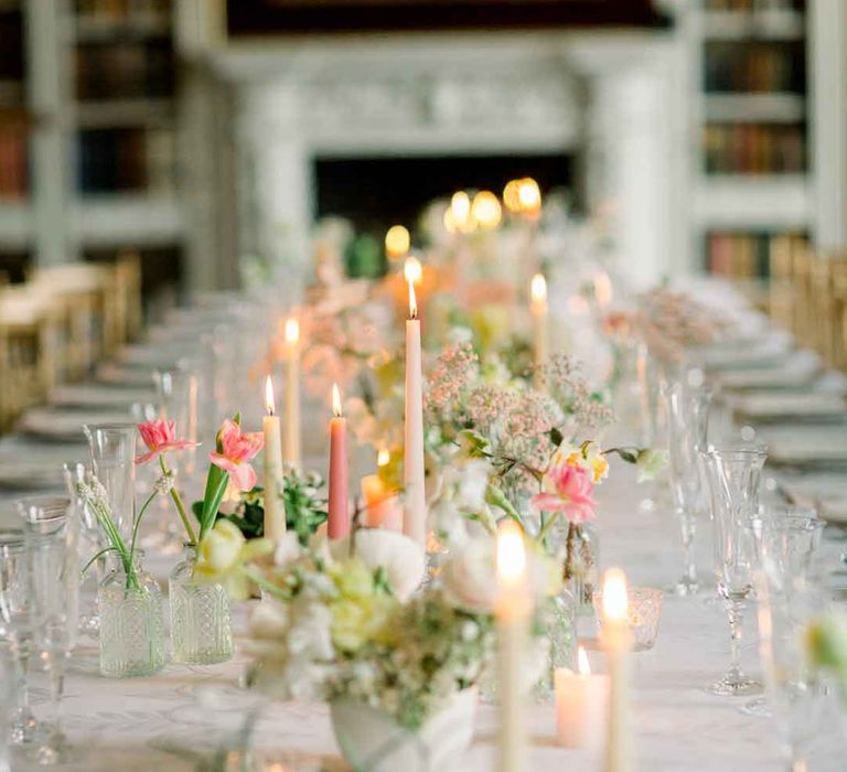 Classic wedding tablescape with pink tapered candles, white tablecloth and spring florals at St Giles House