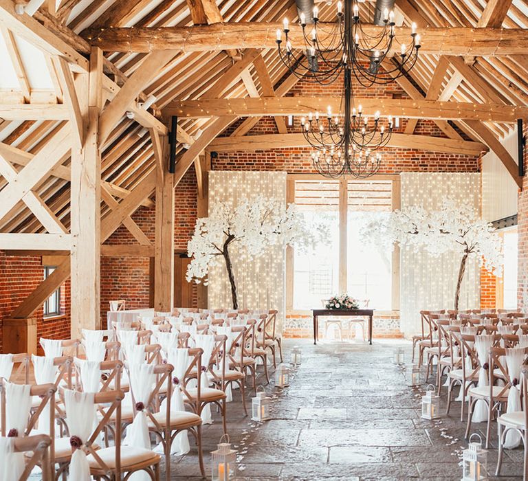 Rackleys Chiltern Hills barn wedding venue in Buckinghamshire with white blossom trees decorating the altar 