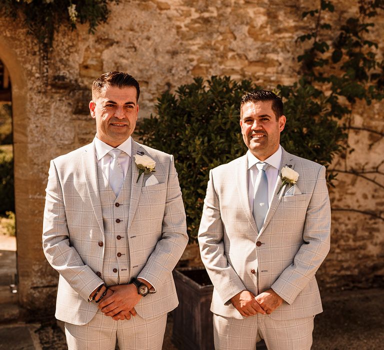 groomsmen in grey check wedding suits at outdoor wedding with Bulgarian wedding traditions