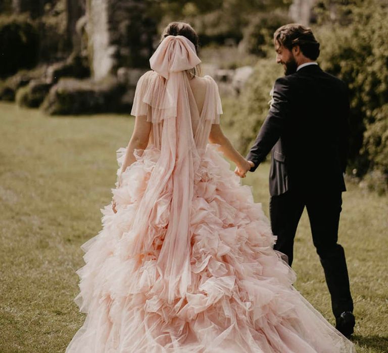 Epic ruffle wedding dress with bride wearing ruffle bow hair accessory 