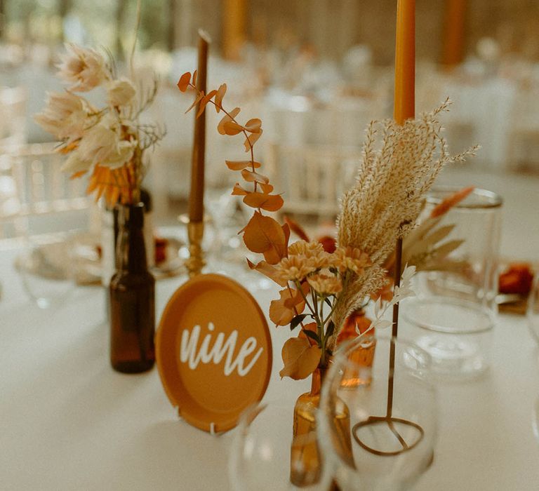 St Tewdrics House Chepstow with autumnal wedding table decorations with DIY table number sign on terracotta plates