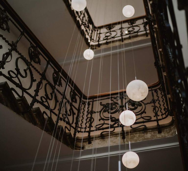 Circular hanging moon lights in La Cabane Des Praz ski wedding