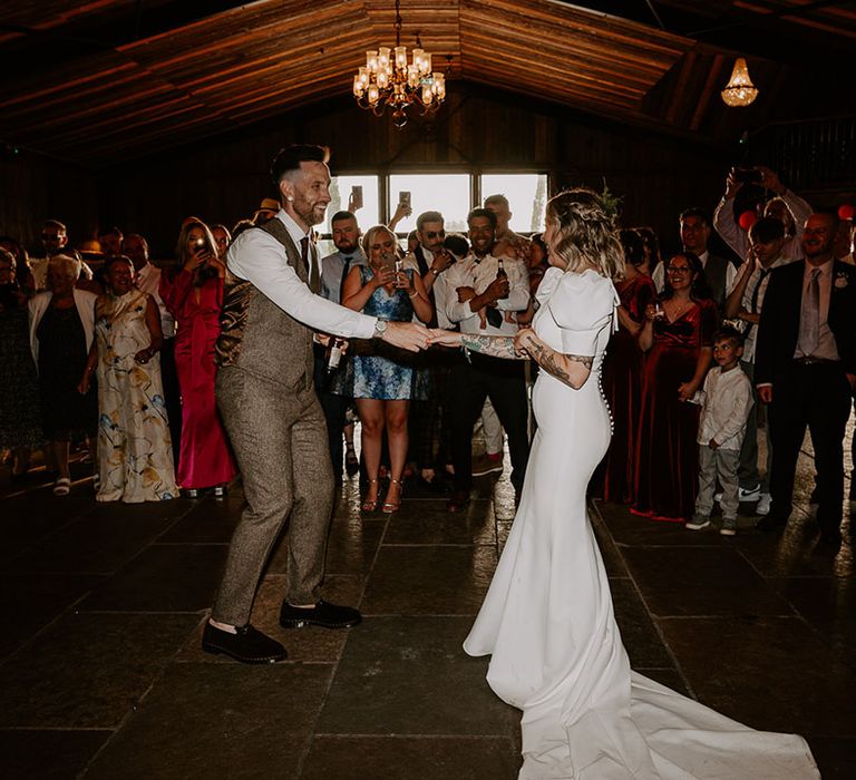 The bride and groom have their first dance together at rustic barn wedding venue in the East Midlands 