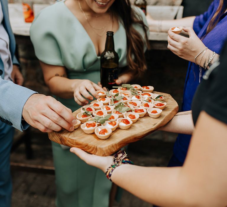 Wooden platter of canapés for guests to enjoy 