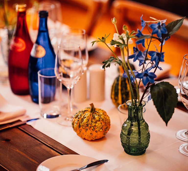 Mismatched wedding table decorations with colourful wedding flowers 