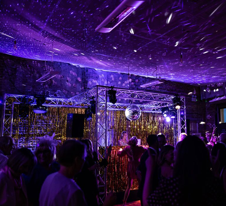 DJ plays at wedding reception with laser lights and disco ball 