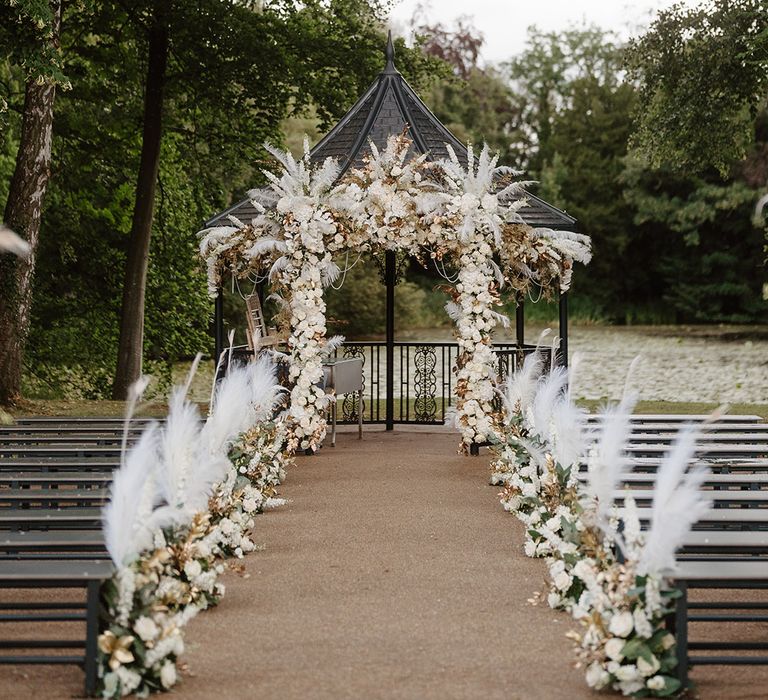 White roses, orchids and pampas grass aisle and altar decorations 