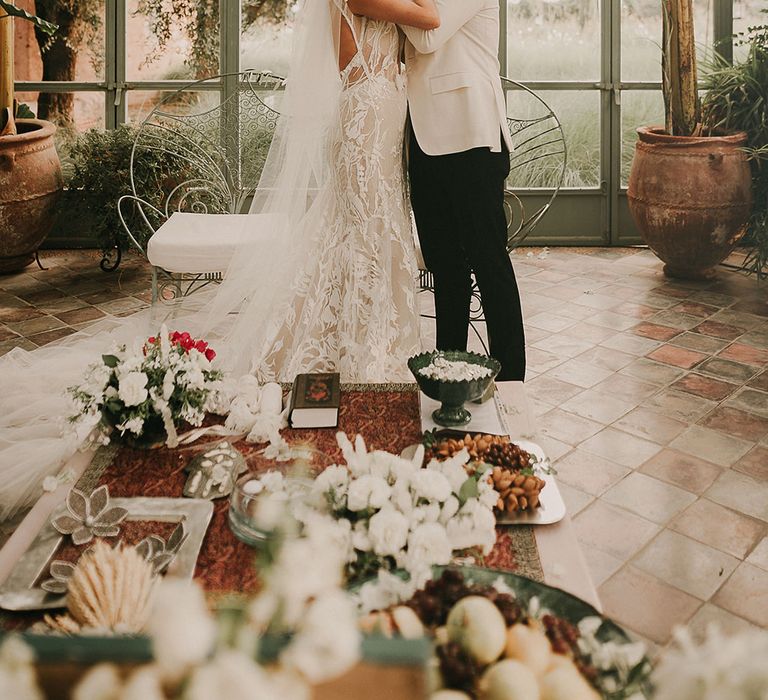 Bride and groom kissing at botanical Marrakech Wedding ceremony 