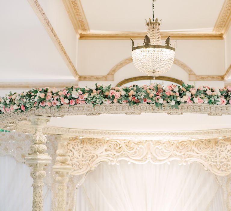 Mandap decorated with white and pink wedding flowers 