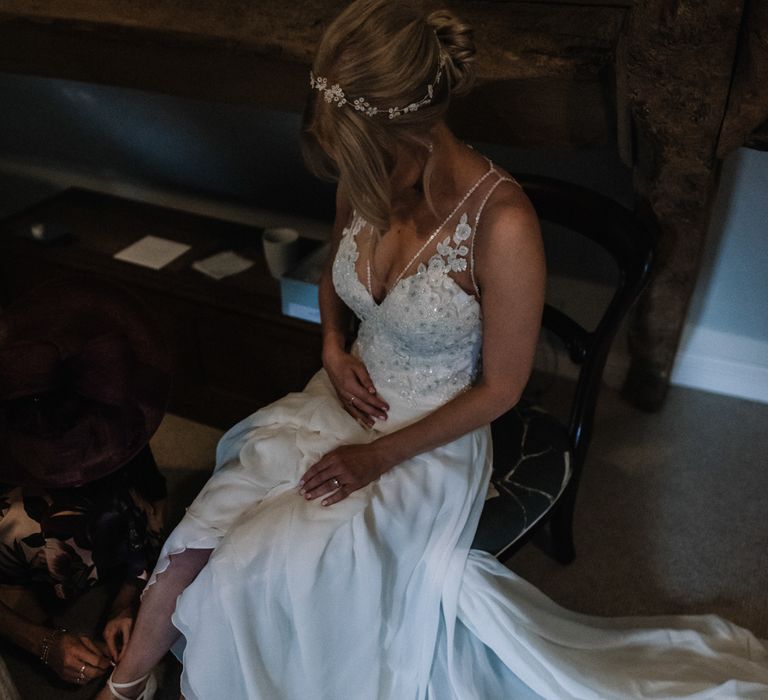 Bride getting ready wearing Riada by Atelier Pronovias wedding dress