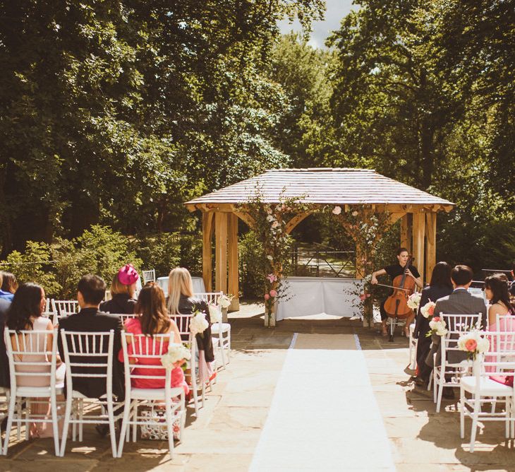 Cellist at outdoor wedding ceremony 