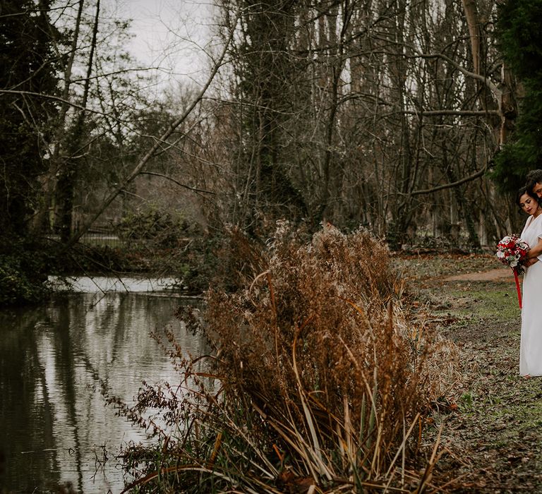 Bride and Groom embrace by lake in Oxford