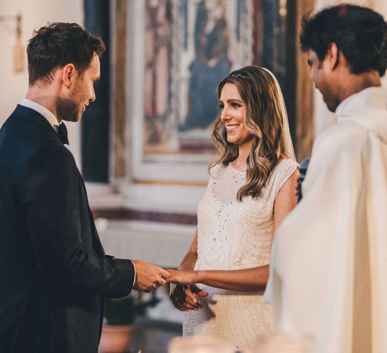 Bride and groom taking vows at Tuscany Italy wedding 