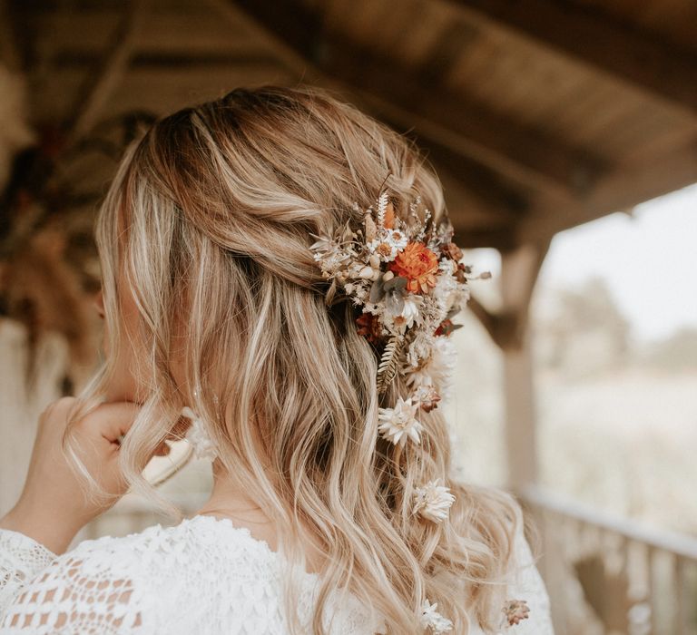 Boho chic hairstyling with floral accessories and loose curls 