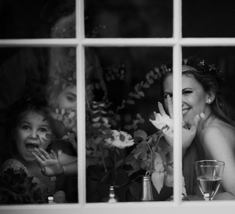 Wedding guests wave out of the window at highland wedding