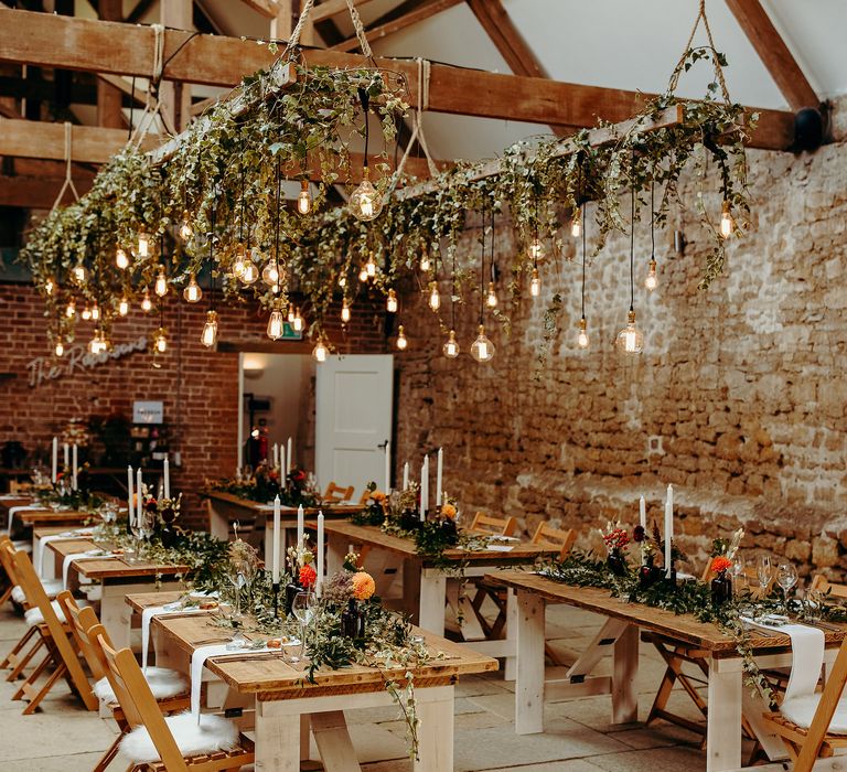 Rustic reception decor with hanging lights, Autumnal colour scheme and hanging ivy 