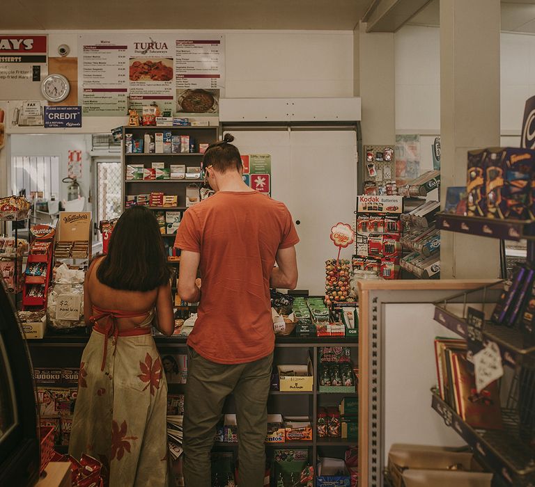 The bride and groom stopping at a convenience store for ice lollies