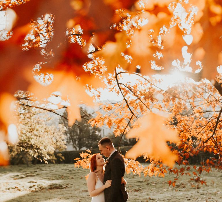 Bride and groom photography outside in nature on an autumn day